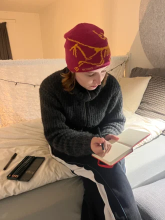Person pausing to think while creating a drawing
